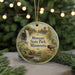 A circular ornament featuring a scenic landscape of Minnesota State Park, with a bison in the foreground and a waterfall in the background.