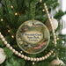 A round ornament hanging on a Christmas tree, featuring a scenic image of Moccasin Creek State Park, Georgia.