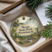 A decorative ornament with a scenic landscape of Moore State Park, Massachusetts, featuring a castle, trees, and a waterfall.