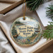 A decorative ornament with a moose and pine trees, featuring the text " Moose Point State Park, Maine" on it, placed in a box with pine branches.