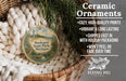 Ceramic ornaments, including a round ornament with a lighthouse and a wicker basket, are displayed on a bed of white yarn.