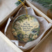 A decorative ornament in a box, featuring a scenic image of a house, trees, and a river, with the text "My Old Kentucky Home State Park Kentucky" printed on it.