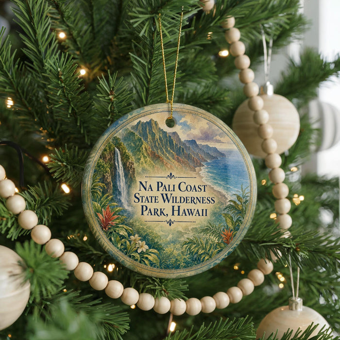 A circular ornament hanging on a Christmas tree, featuring a scenic image of the Na Pali Coast State Wilderness Park in Hawaii.