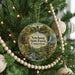 A Christmas tree decorated with ornaments, including a circular ornament with a scenic image of the Natchaug State Forest in Connecticut.