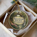A round ornament with a scenic image of the Natural Bridge in Massachusetts, featuring a stone bridge surrounded by trees and a waterfall.