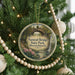 A round ornament on a Christmas tree, featuring a scenic image of the Natural Bridge in Massachusetts.
