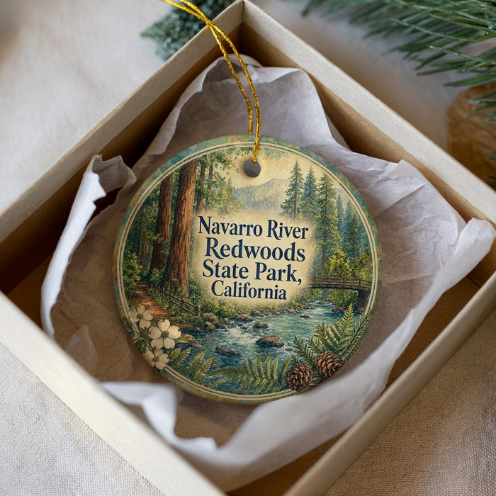 A decorative ornament in a white box, featuring a scenic image of the Navarro River and Redwoods State Park in California.