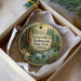 A decorative ornament in a white box, featuring a scenic image of the Navarro River and Redwoods State Park in California.