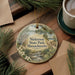 A round ornament with a scenic landscape of Nickerson State Park, Massachusetts, featuring a river, pine trees, and a castle.