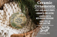 Ceramic ornaments, featuring a round ornament with a lighthouse and greenery, are displayed in a basket.