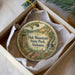 A round ornament with a scenic illustration of Oak Mountain State Park, Alabama, hanging from a string.