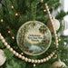 A round ornament hanging on a Christmas tree, featuring a scenic view of Ochlockonee River State Park, Florida.