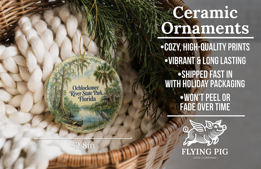 Ceramic ornaments, featuring a painting of a river and palm trees, are displayed in a basket.