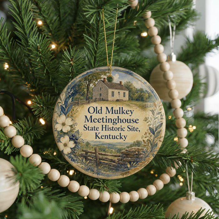 A Christmas tree decorated with ornaments, including a round ornament with a picture of an old mulkey house and the text "Old Mulkey Meetinghouse State Historic Site, Kentucky".