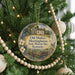 A Christmas tree decorated with ornaments, including a round ornament with a picture of an old mulkey house and the text "Old Mulkey Meetinghouse State Historic Site, Kentucky".
