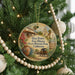 A round ornament hanging on a Christmas tree, featuring an illustration of a historic building and a wagon, with the text "Old Town San Diego State Historic Park, California" and "Fiesta Reves" displayed.