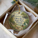 A round ornament with a scenic image of the Oleta River State Park in Florida, featuring a bird, a boat, and a person kayaking.