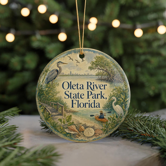 A round ornament with a scenic image of the Oleta River State Park in Florida, featuring a bird, a boat, and a person kayaking.