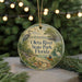 A round ornament with a scenic image of the Oleta River State Park in Florida, featuring a bird, a boat, and a person kayaking.