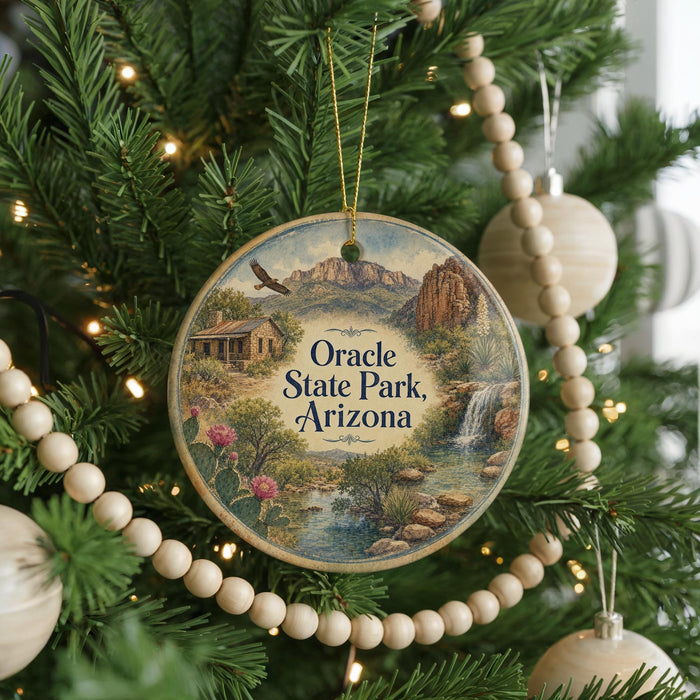 A circular ornament hanging on a Christmas tree, featuring a scenic image of Oracle State Park, Arizona.