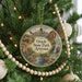 A circular ornament hanging on a Christmas tree, featuring a scenic image of Oracle State Park, Arizona.