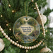 A round ornament hanging on a Christmas tree, featuring a scenic image of Patuxent River State Park, Maryland.