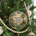 A round ornament hanging on a Christmas tree, featuring a scenic image of a bird, a cow, and a palm tree, with the text "Paynes Prairie Preserve State Park, Florida" displayed on it.