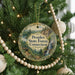A Christmas tree decorated with ornaments, including a circular ornament with a scenic landscape and text that reads "Peoples State Forest, Connecticut".