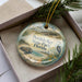 A decorative ornament in a box, featuring illustrations of a turtle, a bird, and a beach scene, with the text "Peridodo Key State Park, Florida" printed on it.
