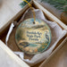 A decorative ornament in a box, featuring illustrations of a beach scene, a bird, and a turtle, with the text "Perdo Key State Park, Florida" printed on it.