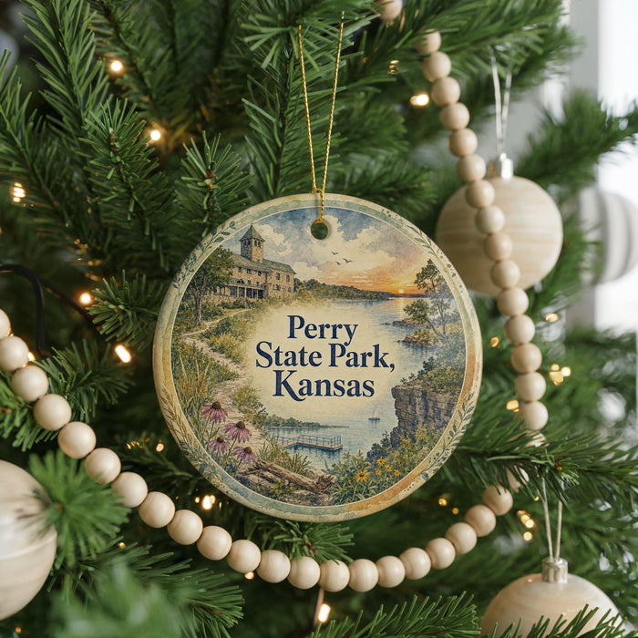 A round ornament hanging on a Christmas tree, featuring a scenic image of Perry State Park in Kansas.