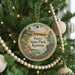 A round ornament hanging on a Christmas tree, featuring a scenic image of Perry State Park in Kansas.