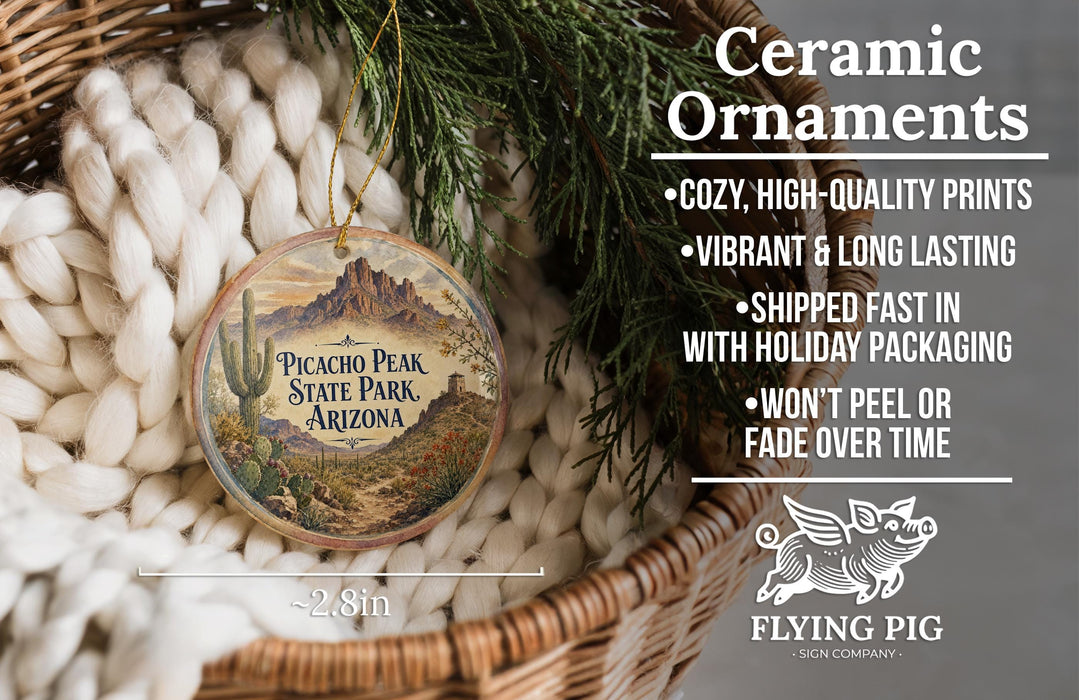 Ceramic ornaments, featuring a decorative design of a mountain range and desert landscape, are displayed in a woven basket.