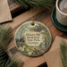 A decorative ornament featuring a scenic image of Pickett's Mill Battlefield State Park, Georgia, surrounded by pine branches and a cup of coffee on a wooden surface.