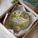 A decorative ornament in a box, featuring a painting of Pico Pico State Historic Park in California.