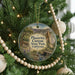 A round ornament hanging on a Christmas tree, featuring a scenic image of Placerita Canyon State Park, California.