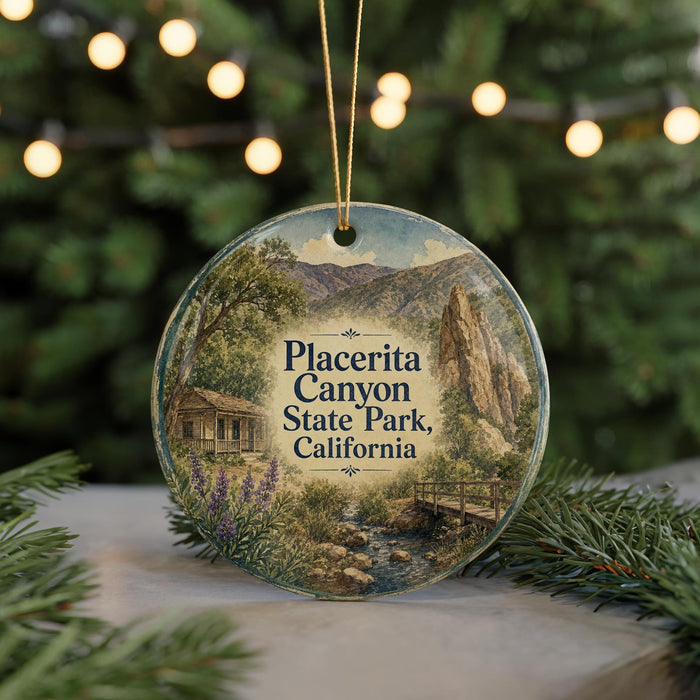 A circular ornament featuring a scenic image of Placerita Canyon State Park, California, with a small cabin and a bridge in the background.