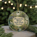 A round ornament with a painting of a bird, a boat, and a house, surrounded by greenery, with the text "Pocomoke River State Park, Maryland" displayed on it.