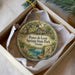 A decorative ornament in a box, featuring a scenic illustration of Ponce de Leon Springs State Park in Florida.