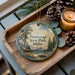 A decorative ornament featuring a scenic landscape of Ponderosa State Park, Idaho, with pine trees, a lake, and mountains in the background.