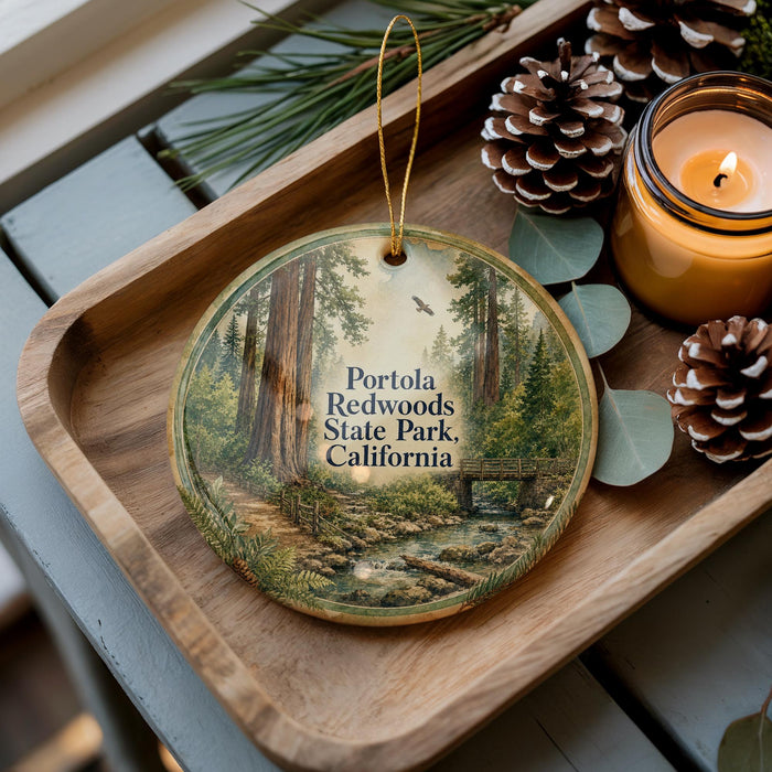 A wooden tray with a decorative ornament featuring a scenic image of Portola Redwoods State Park, California, and pine cones.
