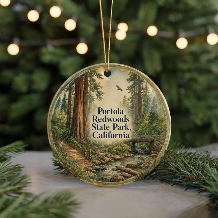A circular ornament featuring a scenic image of Portola Redwoods State Park in California, with a path leading through the forest and a bird flying overhead.