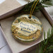 A decorative ornament in a box, featuring a scenic image of Prairie Dog State Park in Kansas.