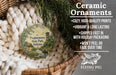 Ceramic ornaments, including a round ornament with a scenic landscape of Prophetstown State Park, Indiana, hanging in a woven basket.