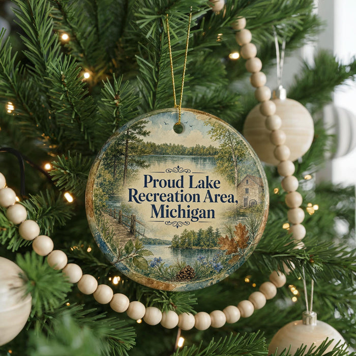 A round ornament hanging on a Christmas tree, featuring a scenic landscape with a lake and trees.