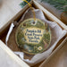 A decorative ornament in a white box, featuring a scenic image of Pumpkin Hill, Creek Preserve, and State Park, Florida.