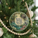 A round ornament hanging on a Christmas tree, featuring a scenic image of Rainbow Springs State Park in Florida.