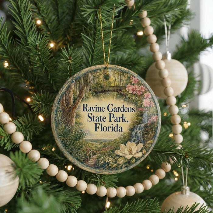 A round ornament hanging on a Christmas tree, featuring a scenic image of Ravine Gardens, State Park, Florida.