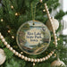 A round ornament hanging on a Christmas tree, featuring a scenic image of Rice Lake State Park, Iowa.