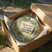 An ornament in a box, featuring a scenic image of a waterfall and forest, with the text "Richard B. Russell State Park, Georgia" printed on it.